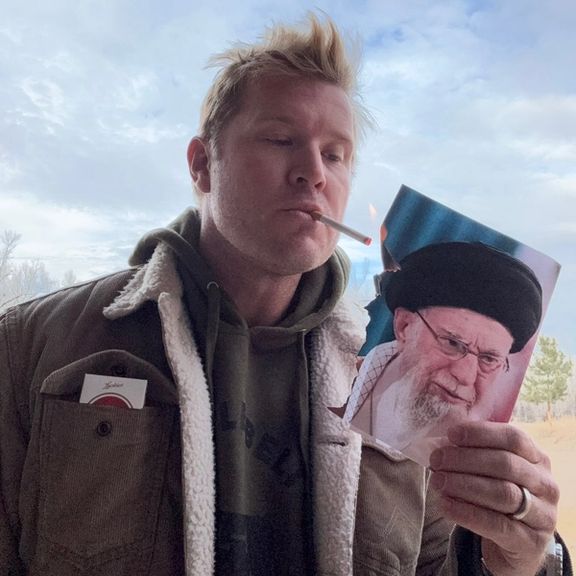 US senator posts photo lighting cigarette with burning image of Khamenei