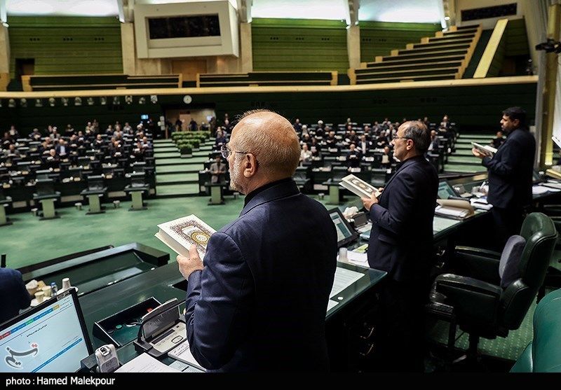 Iran’s Parliament Speaker Mohammad Bagher Ghalibaf (left) holding a copy of the Quran in a symbolic move to condemn the burning of Islam’s holy book during a parliament session in July 2023  