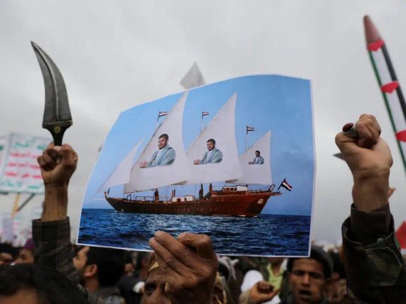 A protester holds a poster during a rally by Houthi supporters to show support to Palestinians in the Gaza Strip, in Sanaa, Yemen April 26, 2024.