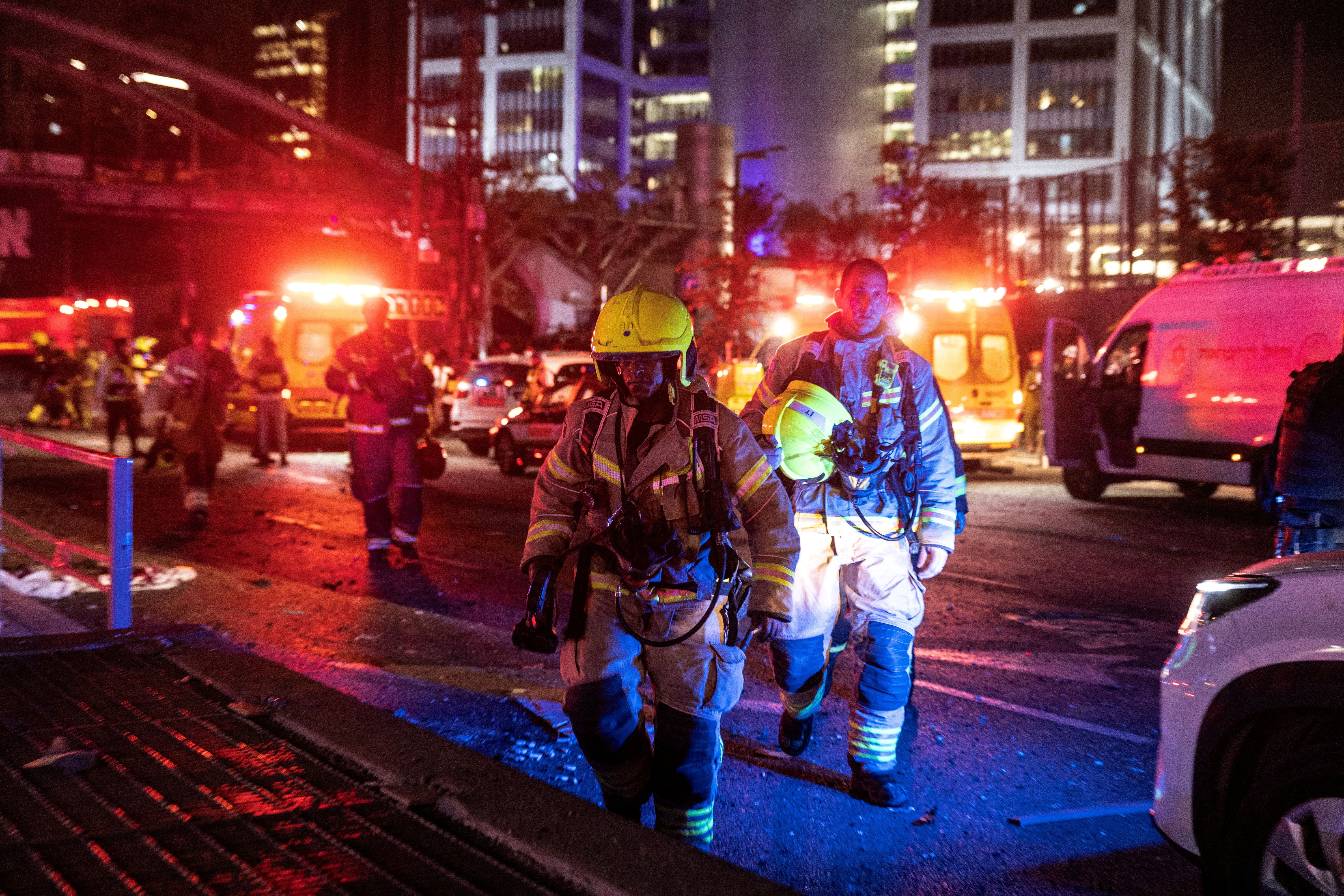 Firefighters work at an impact site following missile attack from Iran on Israel, in Tel Aviv, June 14, 2025.