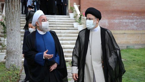 Iran's former president Hassan Rouhani (R) and Ebrahim Raisi in August 2021