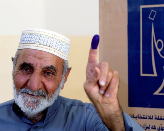 An Iraqi man in Karabla showing his inked finger after voting on Sunday. October 10, 2021