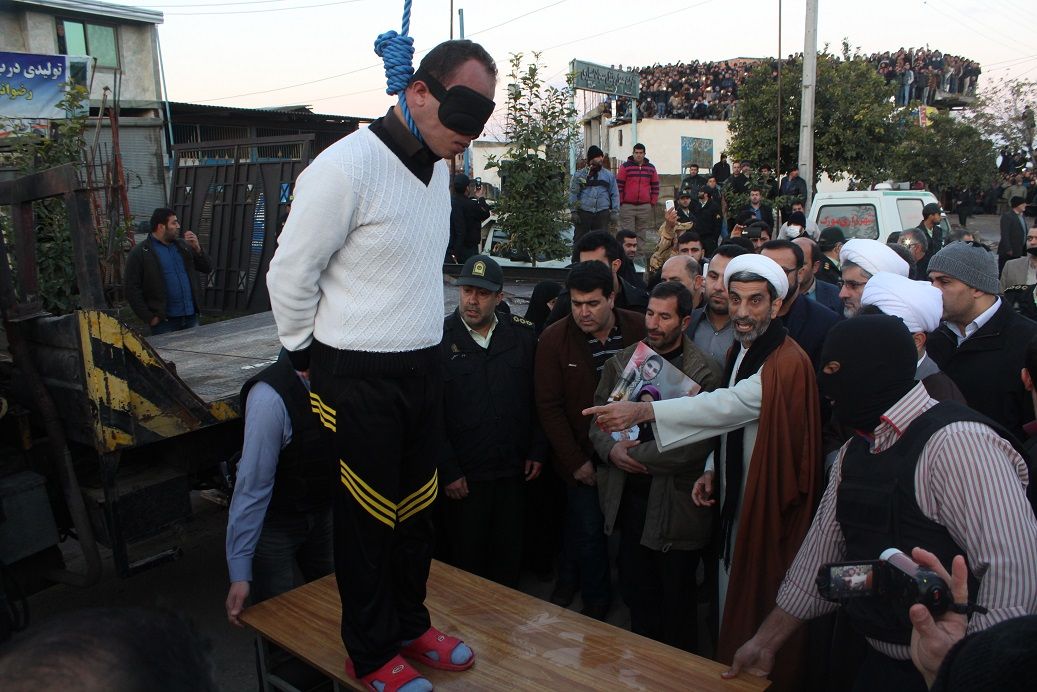 A blindfolded man stands on a platform moments before his public execution in Iran (Undated)