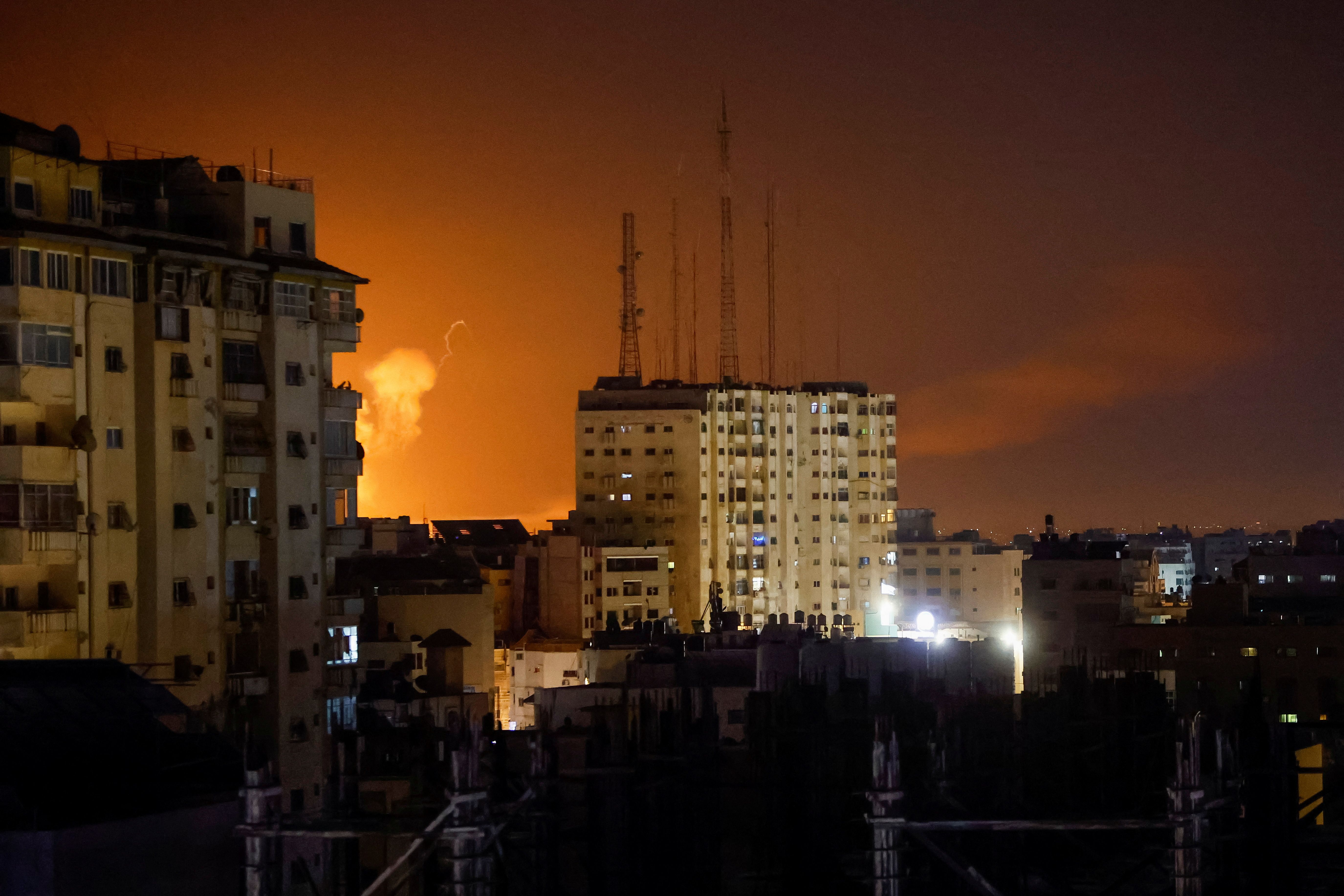 Flames rise above Gaza City, during an Israeli air strike on April 7, 2023.