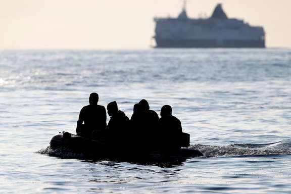 Migrants cross the English Channel in an inflatable boat near Dover, Britain, File Photo.