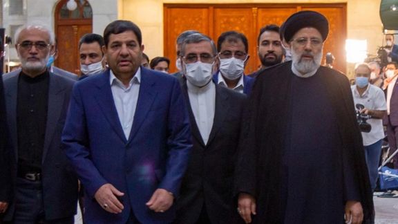 Mogammad Mokhber (L in blue) with President Raisi in August 2021