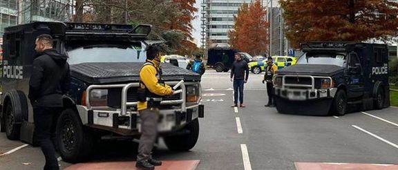 Armored police vehicles are seen outside the former headquarters of Iran International