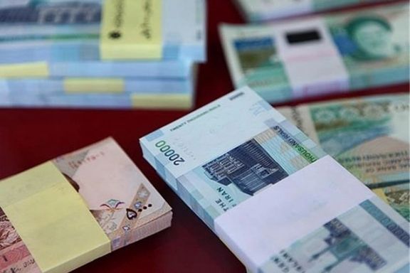 Wads of depreciated Iranian currencies seen at a currency exchange business in Tehran