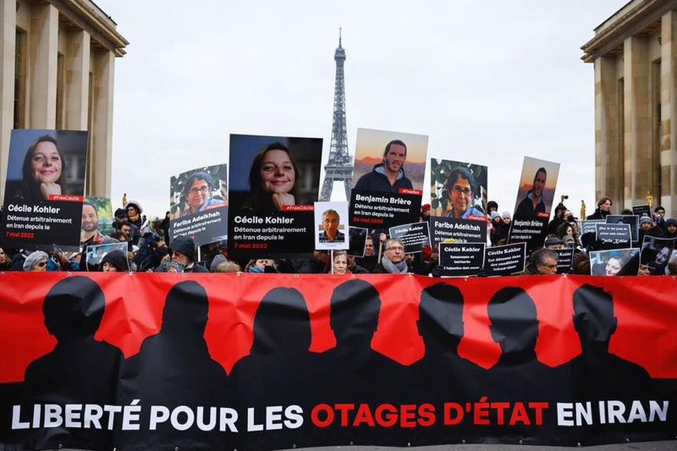 Supporters and relatives of French citizens detained in Iran, Cecile Kohler, Benjamin Briere, Jacques Paris and Fariba Adelkhah, gather in front of the Eiffel Tower during a rally demanding their release, in Paris, France, January 28, 2023