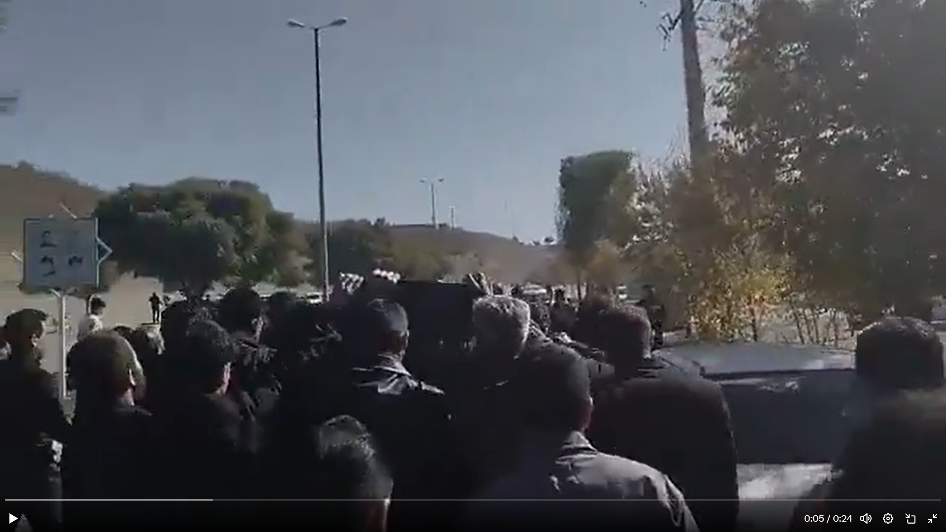 Mourners carry the body of Omid Sarlak during his funeral in Aligoudarz on November 3, 2025.