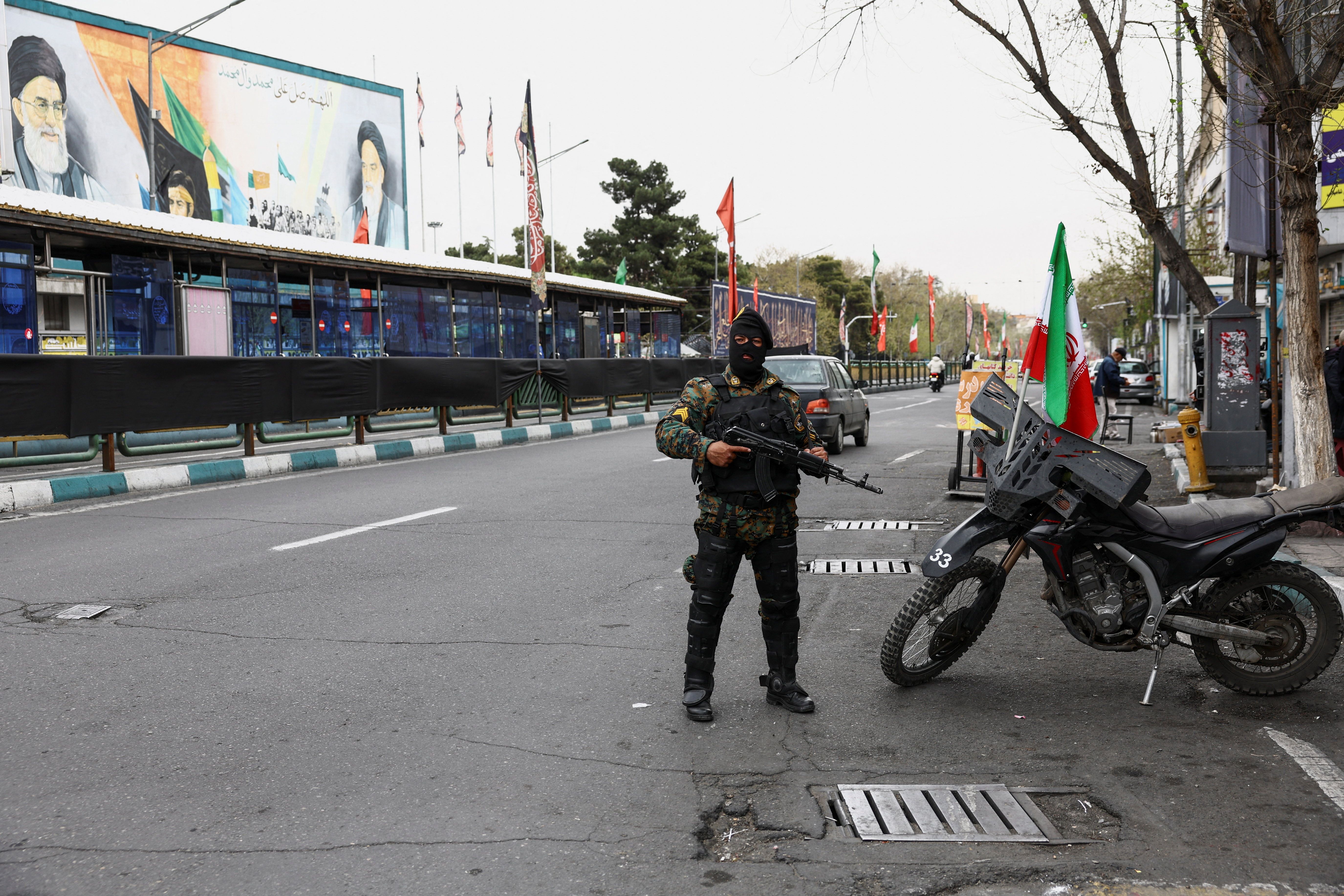 A member of a police force stands guard on a street in Tehran, Iran, March 23, 2026. 