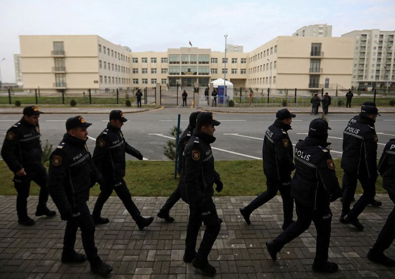 Police officers walk outside a courthouse on the day of the trial of former political figures and officials of the breakaway region of Nagorno-Karabakh, accused of various charges, including genocide and war crimes, in Baku, Azerbaijan January 17, 2025.