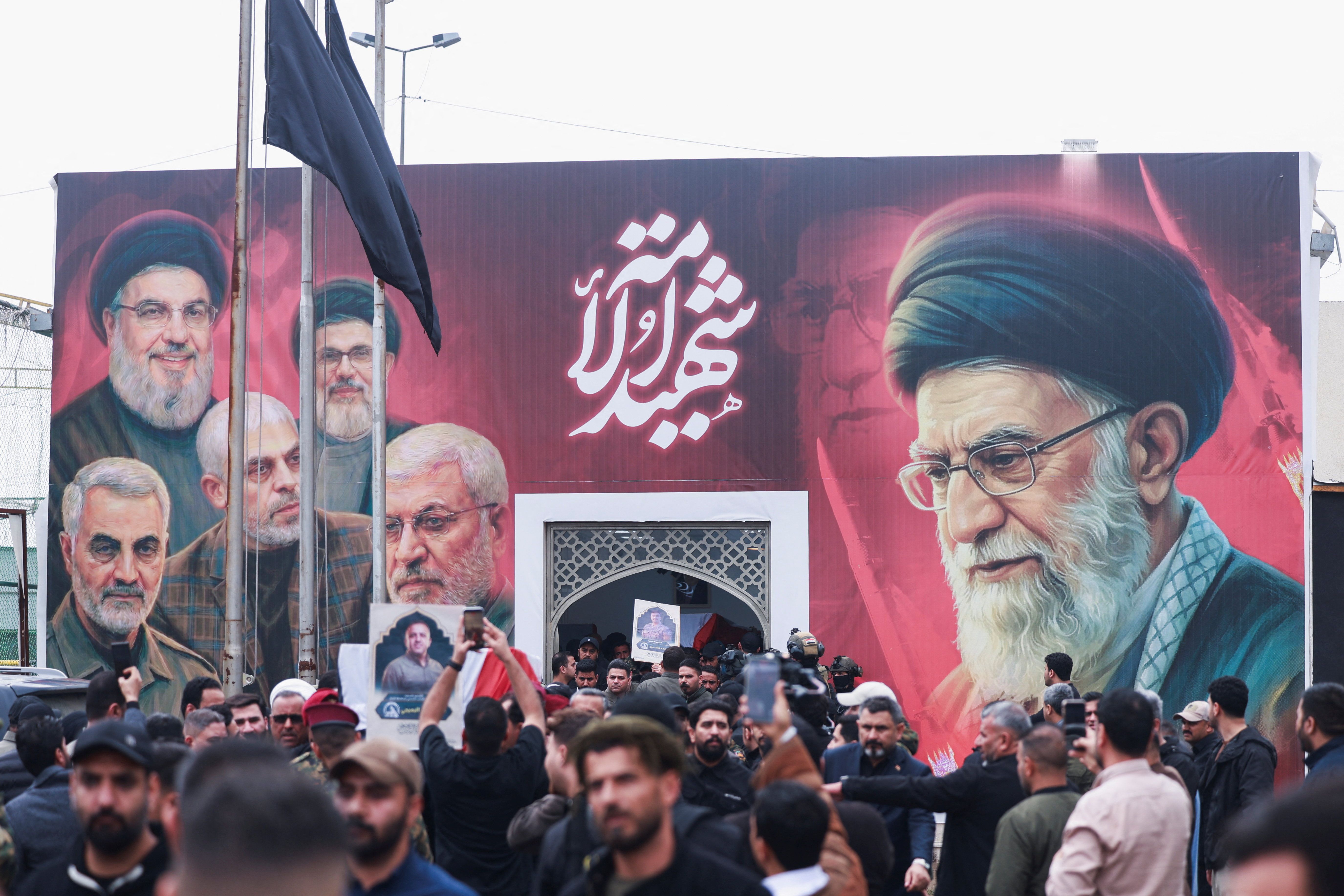 Mourners carry the coffin of Saad al-Baiji, the Popular Mobilisation Forces' Anbar operations commander, who was killed in airstrikes that targeted a PMF site in Iraq's western Anbar province, during his funeral, in Baghdad, Iraq, March 24, 2026.