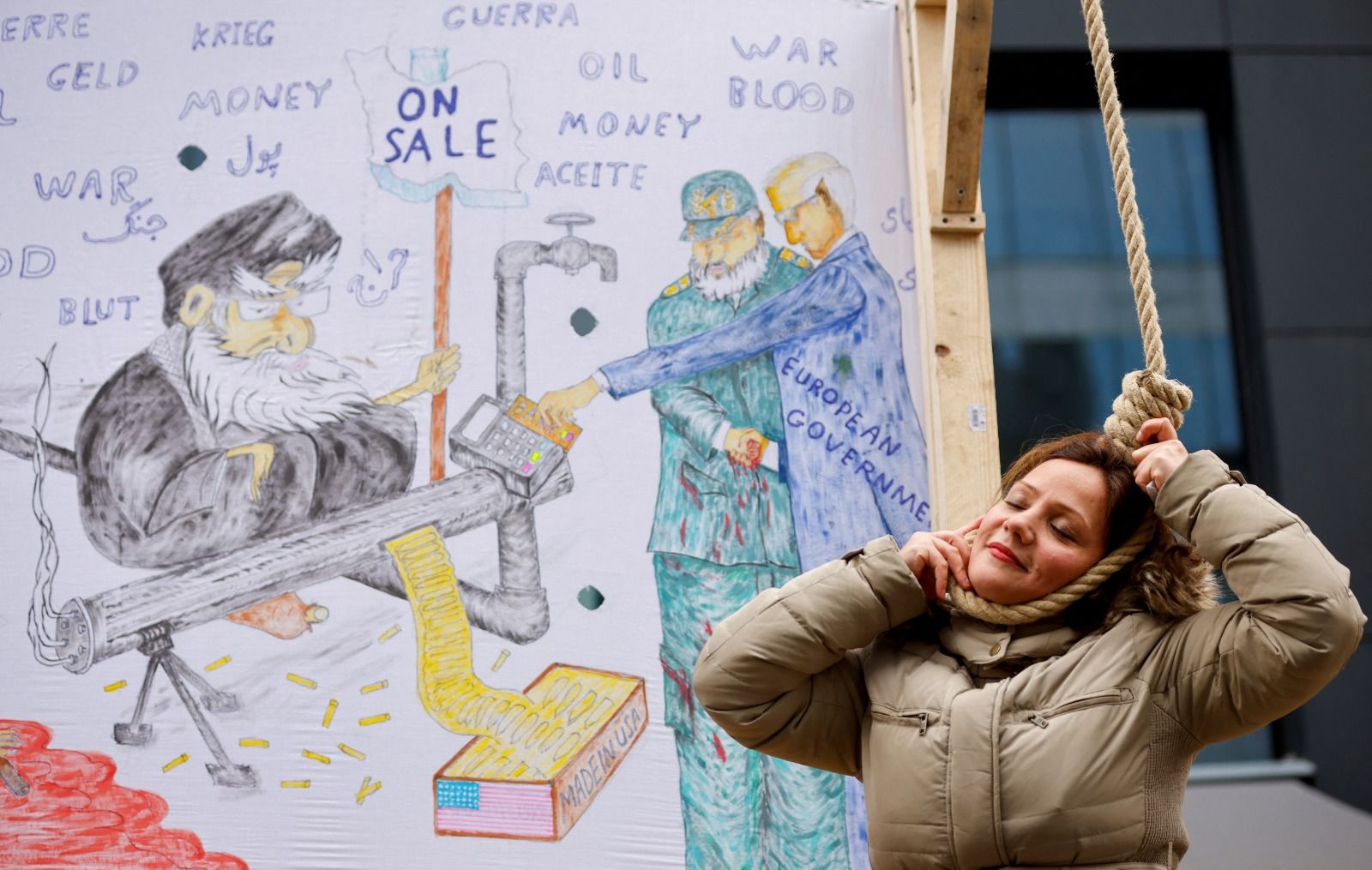 A woman plays the role of a person being hanged as Iranian community member takes part in a protest in solidarity with Iranian people, in Brussels, Belgium, February 20, 2023