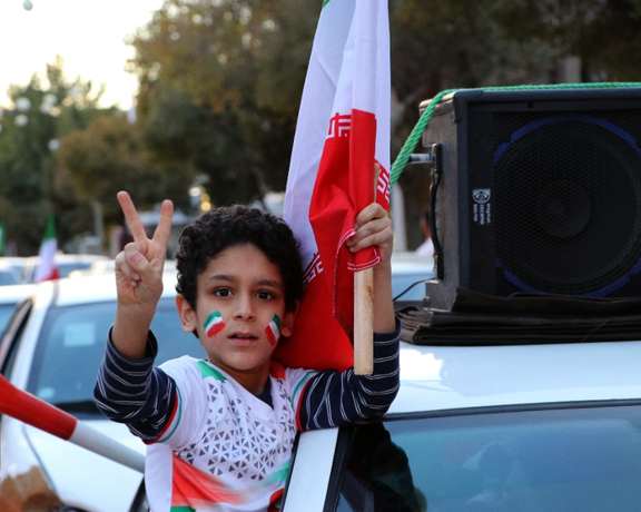 A boy celebrating Team Melli’s victory against Wales in a government-sponsored rally in the city of Kerman, central Iran