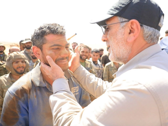 A photo released by Iranian media of IRGC’s Quds Force Commander Esmail Qaani and Syrian fighters in an undisclosed location in Syria