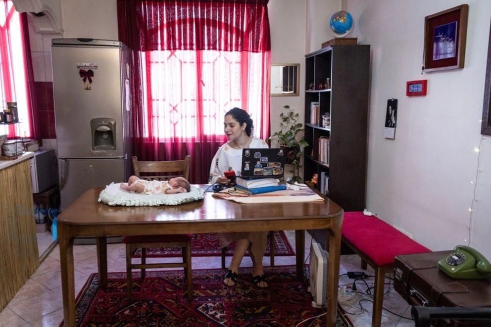 The Iranian influcencer sits beside a baby placed through Iran’s Mizban temporary foster care program.