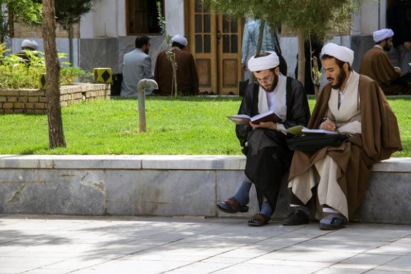 Two young clerics in the courtyard of a seminary. FILE