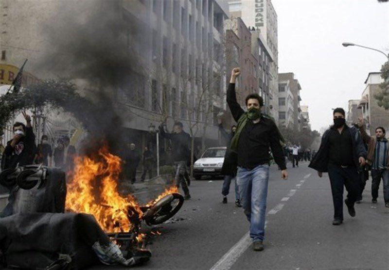 Protesters in the central city of Arak torch a motorcycle used by security forces. Oct. 29, 2022