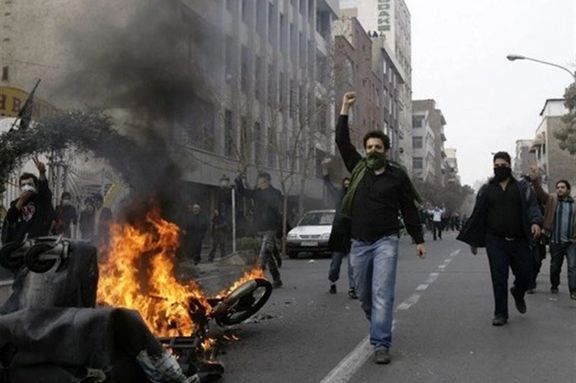 Protesters in the central city of Arak torch a motorcycle used by security forces. Oct. 29, 2022