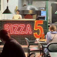 Dollar-pegged pizza in Tehran points to a different kind of regime change