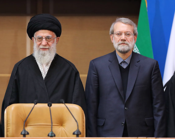 An undated photo showing Larijani next to Khamenei.