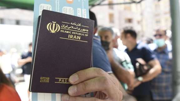A man holding an Iranian passport