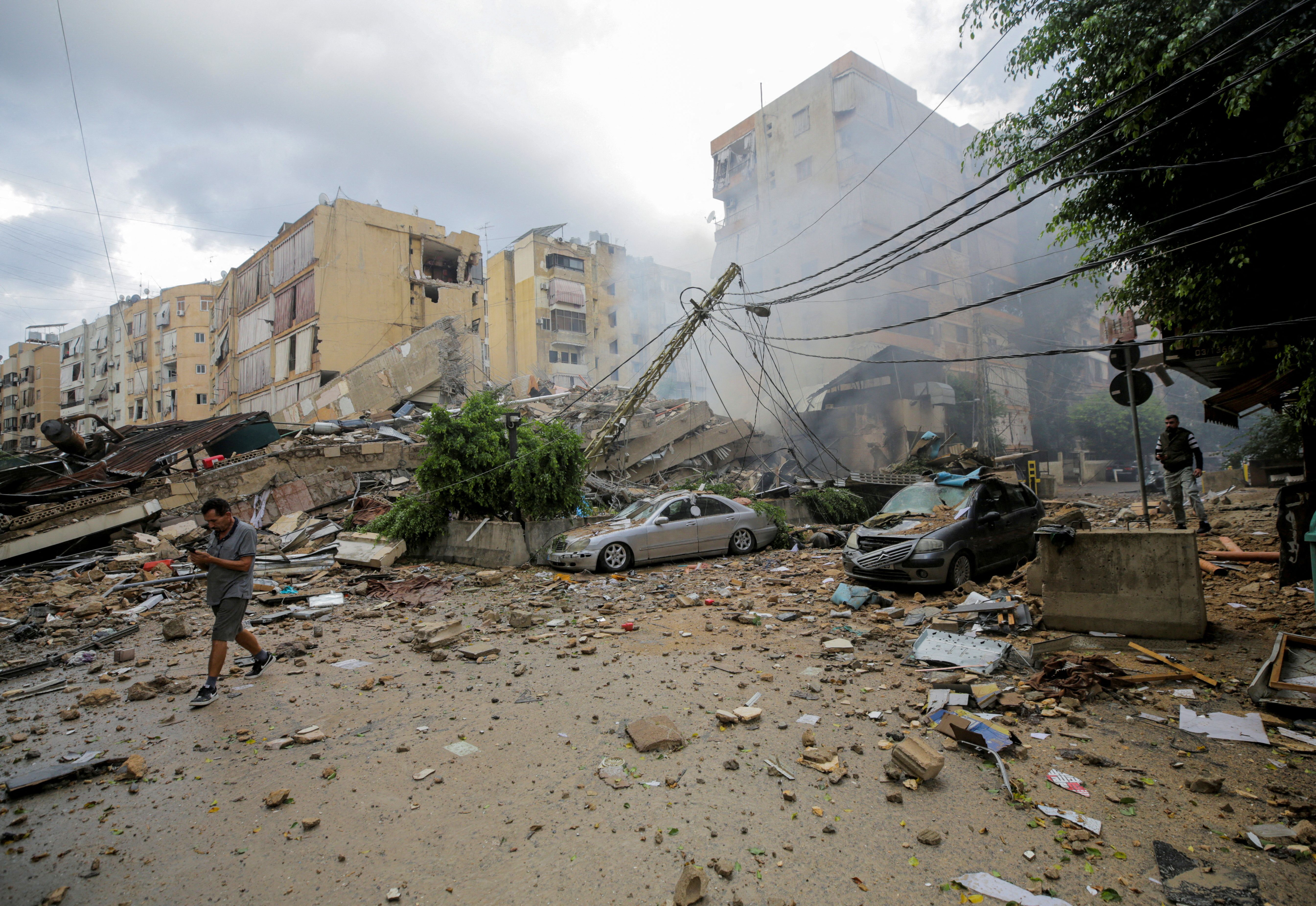 A man walks near damaged buildings, in the aftermath of Israeli strikes on Beirut's southern suburbs, Lebanon October 1, 2024.