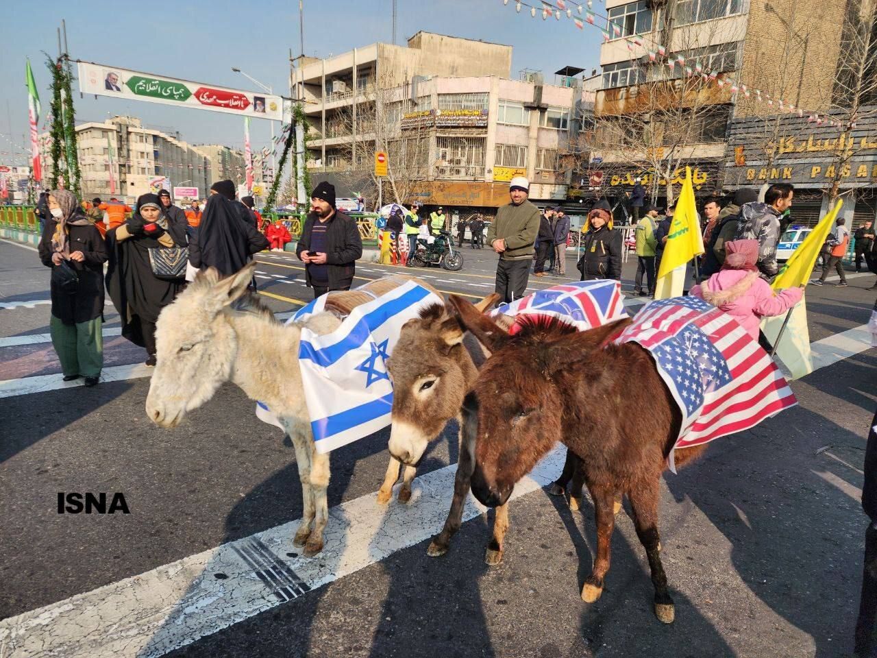 Donkeys draped with US, Israeli, and UK flags are displayed at a state-sponsored rally marking the anniversary of the 1979 Islamic Revolution in Iran, February 10, 2024 