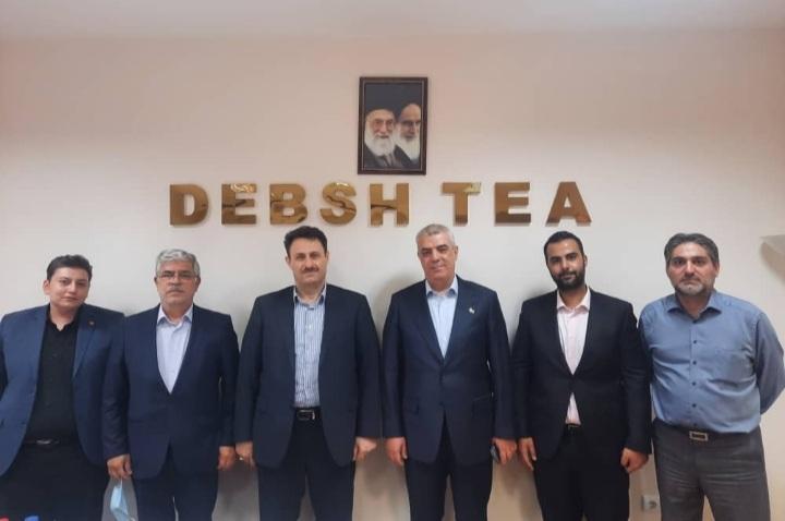 Debsh Tea Company CEO Akbar Rahimi (4th left) among a group of the company’s employees  