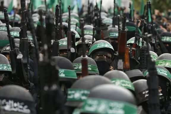 Forces of al-Qassam Brigades, the armed wing of Hamas, in a military parade marking the 27th anniversary of Hamas founding, in Gaza City, on December 14, 2014