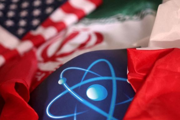 US and Iranian flags with atomic energy logo.
