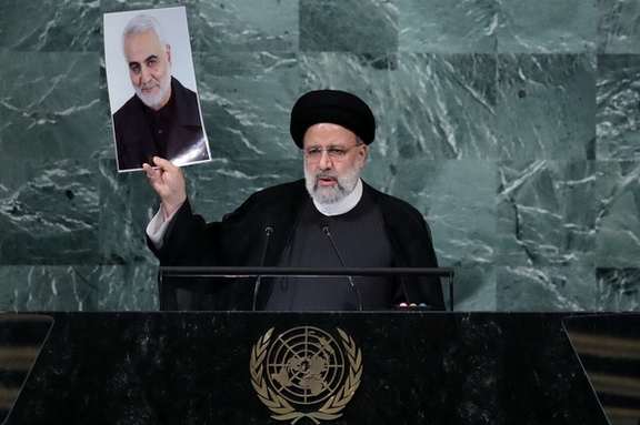 Iran's President Ebrahim Raisi holds up a picture of Quds Force Commander General Qassem Soleimani as he addresses the 77th Session of the United Nations General Assembly at UN Headquarters in New York City, US, September 21, 2022