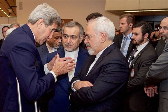 Former US secretary of state John Kerry seen speaking with J. Zarif and Hassan Fereydoun (C).