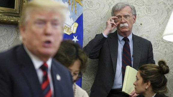 President Donald Trump speaks as National security advisor John Bolton listens during a meeting in the Oval Office of the White House. May 22, 2018