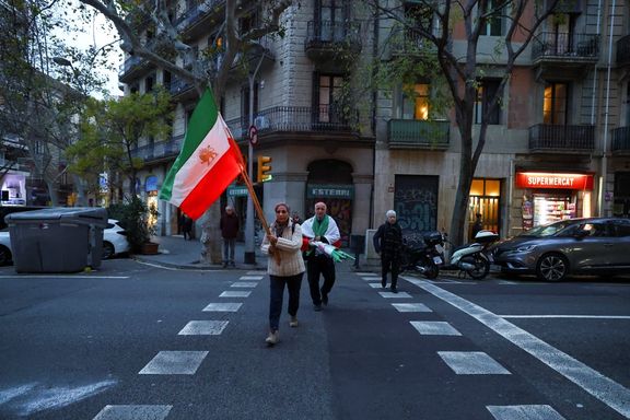 Said and Guiti, who have lived in Spain for over 40 years as refugees from Iran, carry flags to attend a demonstration in support of the national protests in Iran, in Barcelona, Spain January 13, 2026.