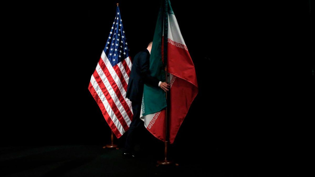 A staff removes the Iranian flag from the stage after a group picture with foreign ministers and representatives of Unites States, Iran, China, Russia, Britain, Germany, France and the European Union during the Iran nuclear talks at the Vienna International Center in Vienna, Austria July 14, 2015. 