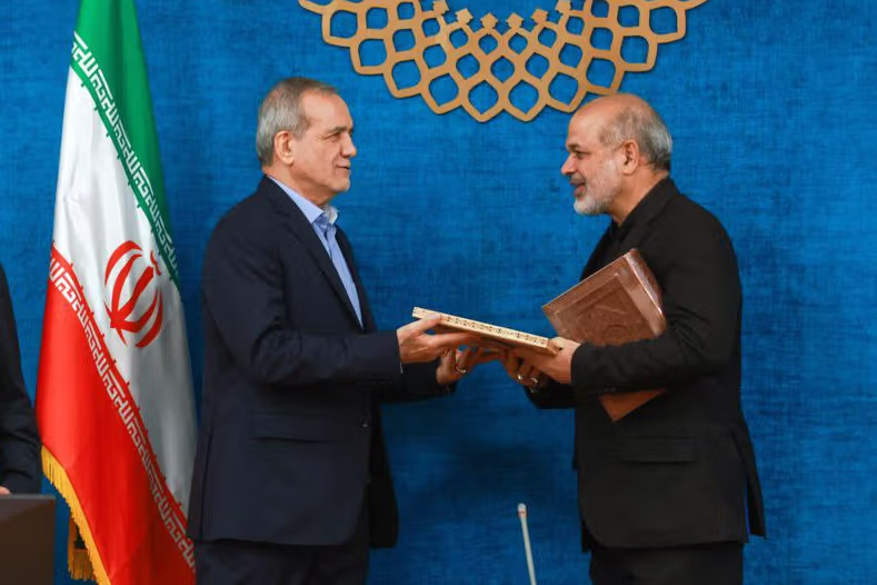 Iran's President Masoud Pezeshkian (left) and Revolutionary Guards Chief-Commander Ahmad Vahidi