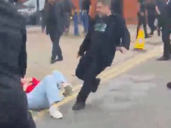 An Iranian woman is seen being beaten to the ground by a man seemingly loyal to the Islamic Republic of Iran during a gathering of Iranian dissidents in London on May 24, 2024