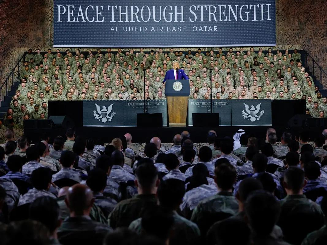 US President Donald Trump delivers remarks to U.S. troops, in front of a banner reading, Peace Through Strength, during a visit to Al Udeid Air Base in Doha, Qatar, May 15, 2025. 