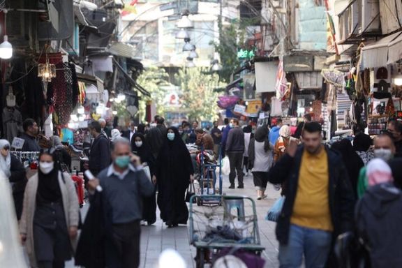 Iranians walk down a market street in Tehran, Iran November 14, 2021.