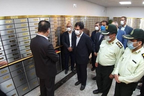 Officials and police inspect a section of safety deposit boxes at Bank Melli. June 6, 2022