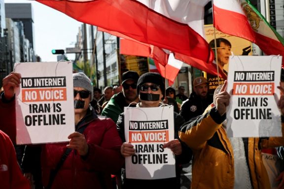 Iranians living in Japan, with taped mouths and carrying signs and flags, march in support of nationwide protests in Iran, in Tokyo, Japan, January 18, 2026.