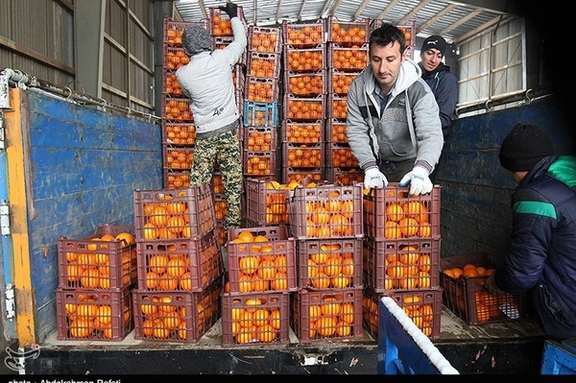 File photo of workers at a fruit and vegetables market in southern Tehran