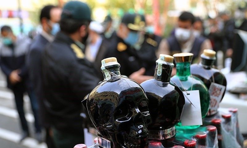 Authorities display confiscated bootleg liquor. (File photo)