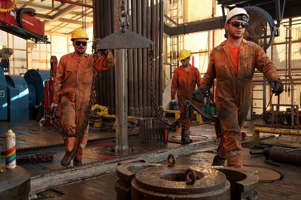 Workers operate an offshore drilling rig in the Iranian sector of the Caspian Sea, undated file photo