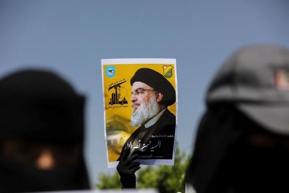 A student in Sanaa, Yemen, holds a poster of Hezbollah leader Hassan Nasrallah during a rally on October 2, 2024, after his killing.