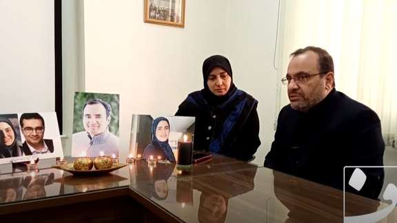 Assadi-Lari family during their interview with photos of their children