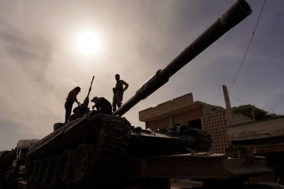 Syrian troops sit atop a tank as they head towards the Syrian-Lebanese border following clashes with Lebanese soldiers and armed groups, in Qusayr, Syria, March 17, 2025.