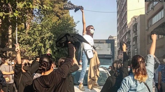 Iranian protesters chanting slogans while unveiling in public